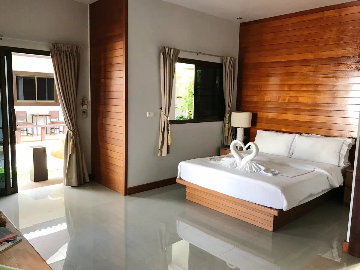Deluxe Room with wood-paneled headboard at The Nest Samui